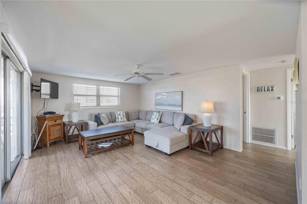 6150 Midnight Pass Road, Unit 10 A&B Sarasota, FL 34242 - Photo 37 of 65 a living room with furniture and a wooden floor