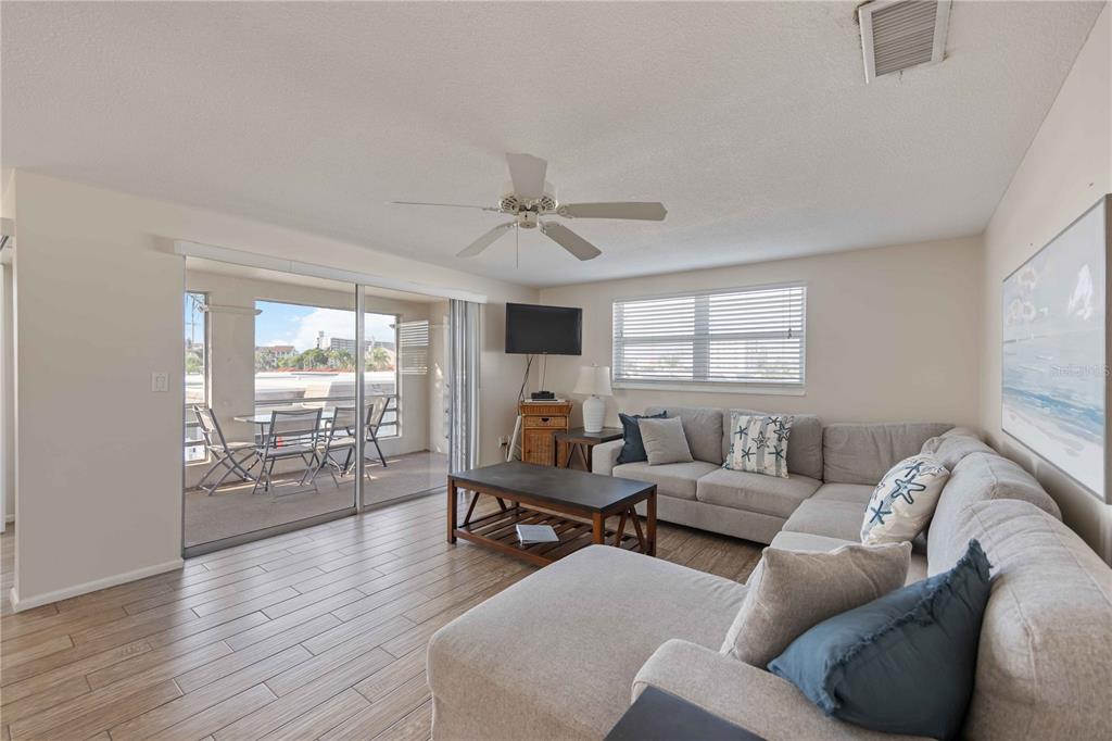 6150 Midnight Pass Road, Unit 10 A&B Sarasota, FL 34242 - Photo 39 of 65 a living room with furniture and wooden floor