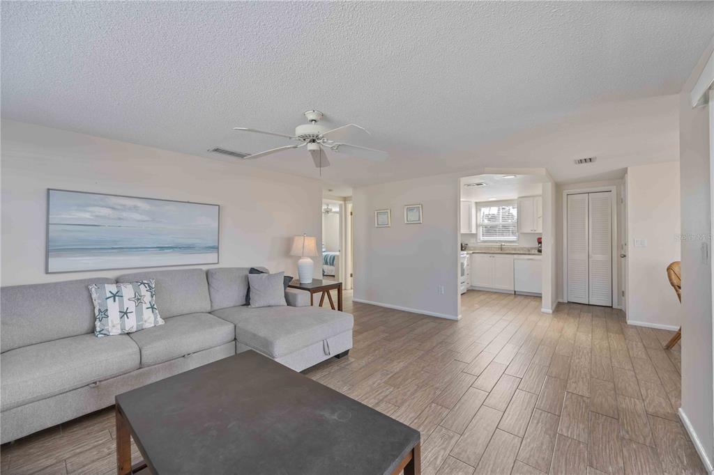 6150 Midnight Pass Road, Unit 10 A&B Sarasota, FL 34242 - Photo 40 of 65 a living room with furniture and wooden floor