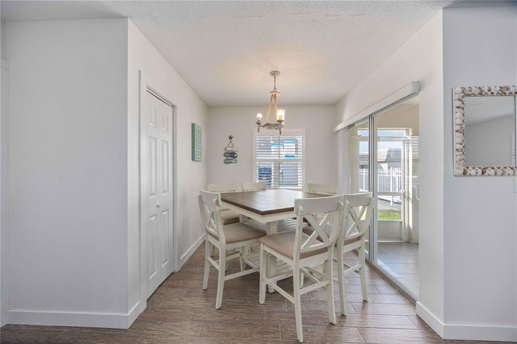 6150 Midnight Pass Road, Unit 10 A&B Sarasota, FL 34242 - Photo 4 of 65 a view of a dining room with furniture window and wooden floor