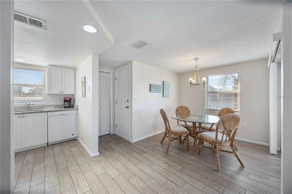 6150 Midnight Pass Road, Unit 10 A&B Sarasota, FL 34242 - Photo 42 of 65 a kitchen with a table and chairs in it