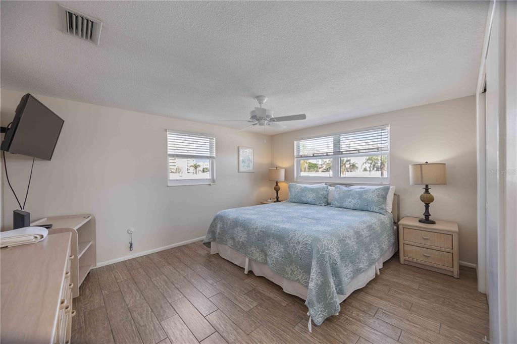 6150 Midnight Pass Road, Unit 10 A&B Sarasota, FL 34242 - Photo 46 of 65 a bedroom with a bed and a night stand