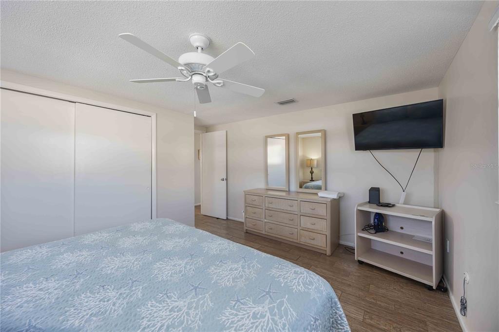 6150 Midnight Pass Road, Unit 10 A&B Sarasota, FL 34242 - Photo 49 of 65 a bedroom with a bed and a flat screen tv