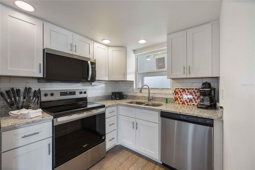 6150 Midnight Pass Road, Unit 10 A&B Sarasota, FL 34242 - Photo 10 of 65 a kitchen with a sink stove and microwave