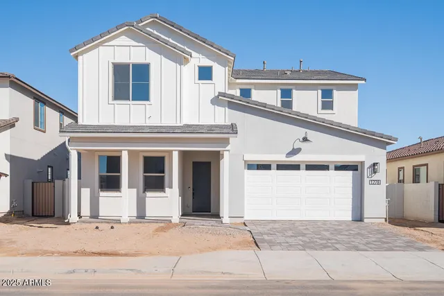 a front view of a house with a garage and balcony
