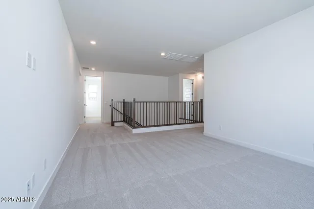 a view of an empty room with stairs