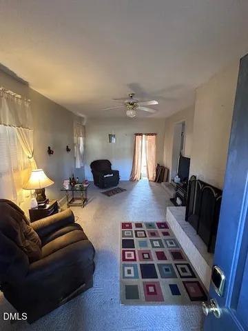 a living room with furniture and a rug
