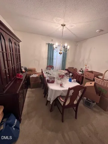 a dining room with furniture and a chandelier