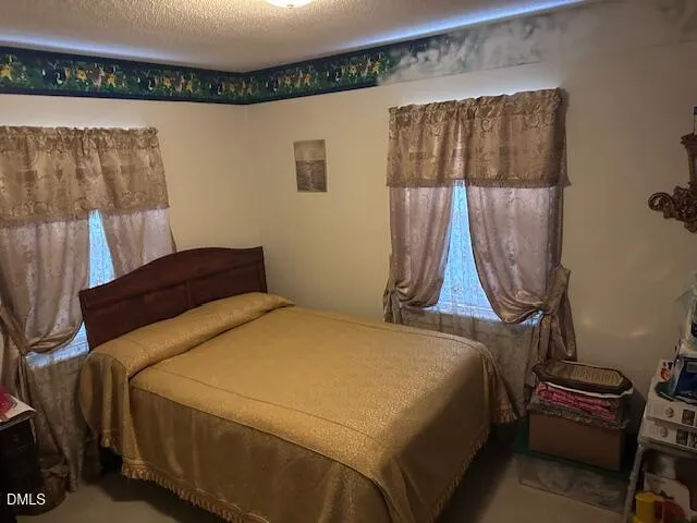 a bedroom with a bed and a table