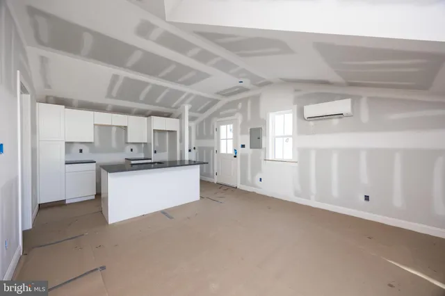 a kitchen with granite countertop a sink and a stove next to a window