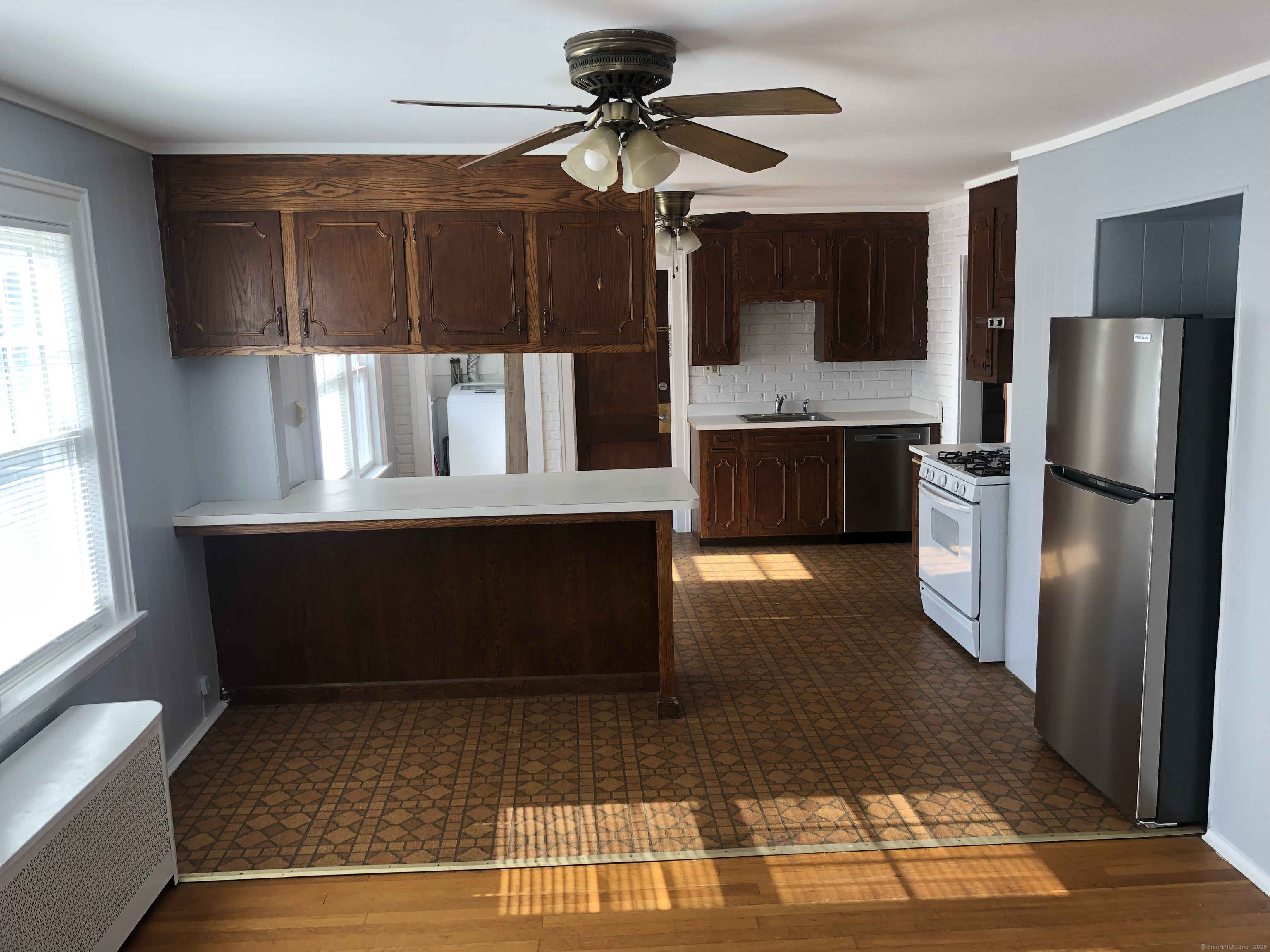317-319 Garden Street Wethersfield, CT 06109 - Photo 12 of 24 a kitchen with stainless steel appliances kitchen island granite countertop a refrigerator and a stove top oven