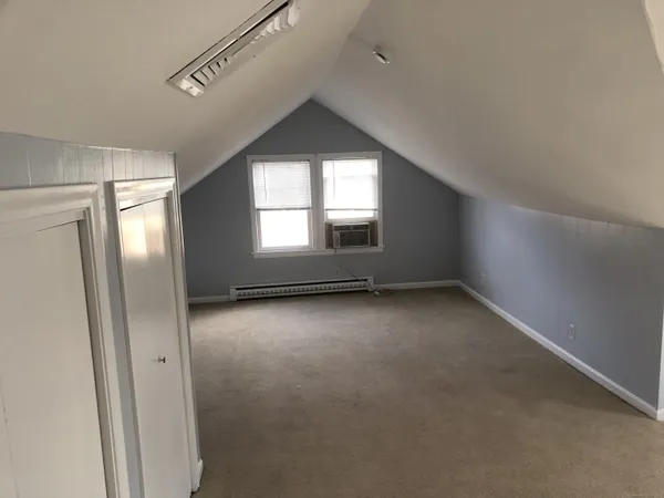 an empty room with windows and closet
