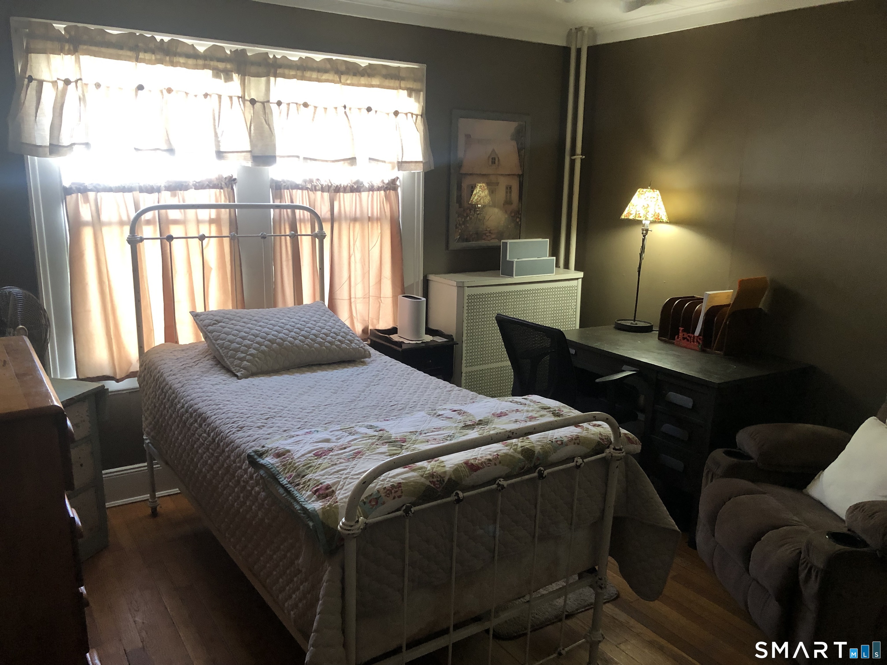 317-319 Garden Street Wethersfield, CT 06109 - Photo 9 of 24 a bedroom with a bed lamps and window