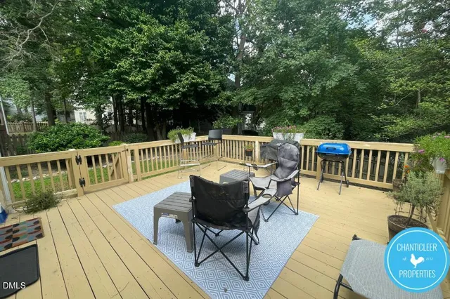 a view of a chairs and table on the wooden deck