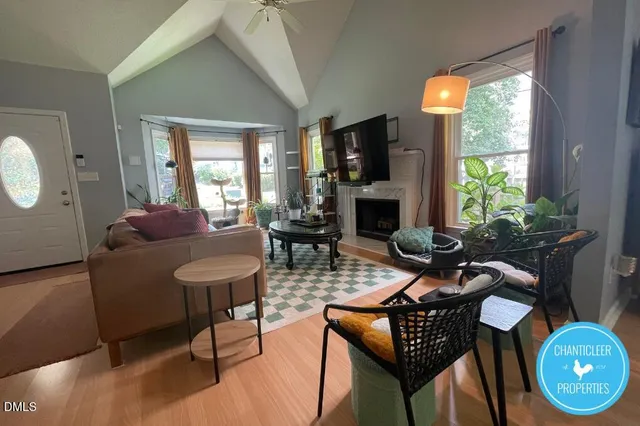 a living room with furniture a fireplace and a floor to ceiling window