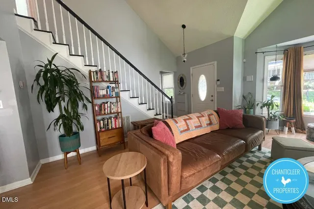 a living room with furniture and wooden floor