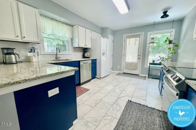 a kitchen with granite countertop a sink stove and cabinets