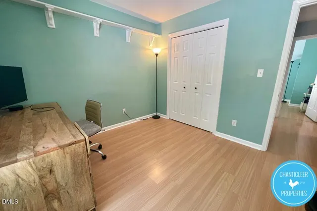 a view of a room with wooden floor