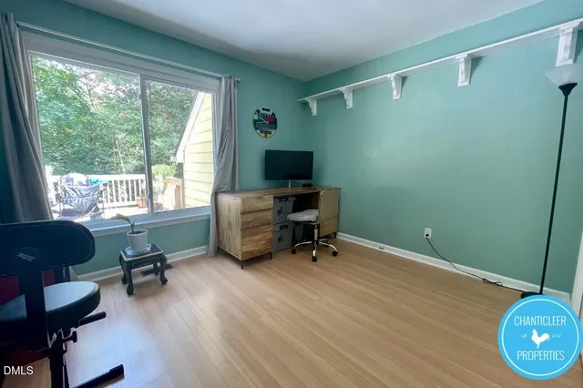 a view of a workspace with furniture and a window