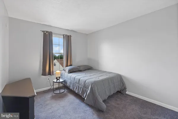 a bedroom with a bed lamp and window