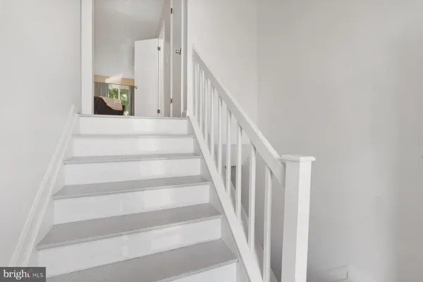 a view of staircase with lots of frames on wall