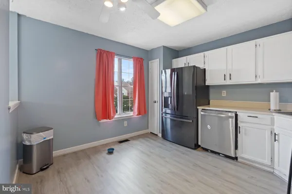 a kitchen with a refrigerator sink and stove
