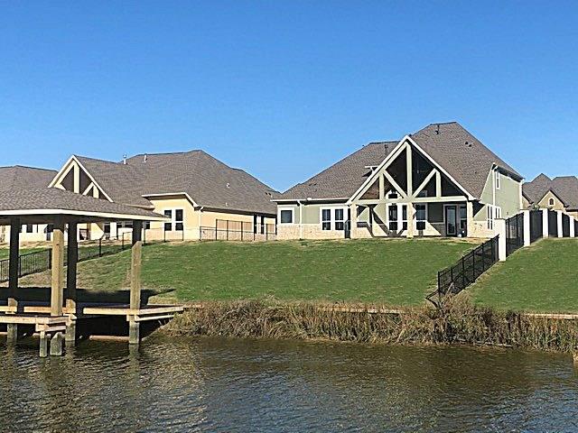 WATERSIDE VIEW OF THIS NEW CONSTRUCTION COMPLETE WITH BOAT HOUSE!  COME AND SEE FIRST HAND THE QUALITY OF CONSTRUCTION, WATER VIEWS AND SEE WHAT THE WATERFRONT LIFESTYLE IS ALL ABOUT!