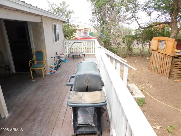 a view of balcony with wooden floor and seating space
