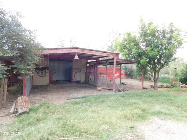 a backyard of a house with a yard and outdoor seating