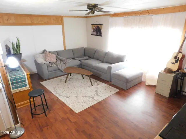 a living room with furniture and a wooden floor