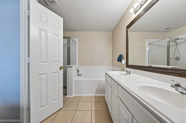 a bathroom with a tub sink and mirror
