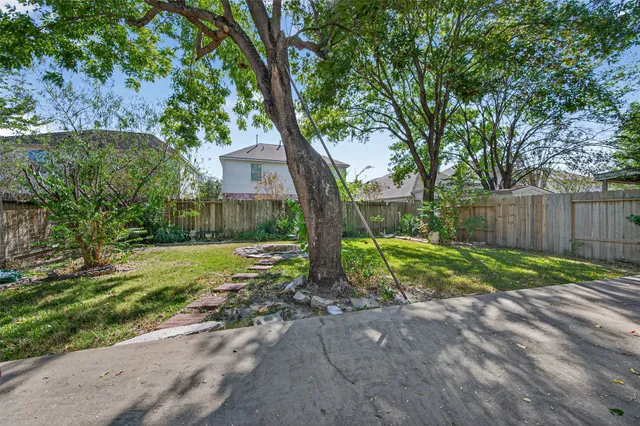 a view of a house with a yard and tree s