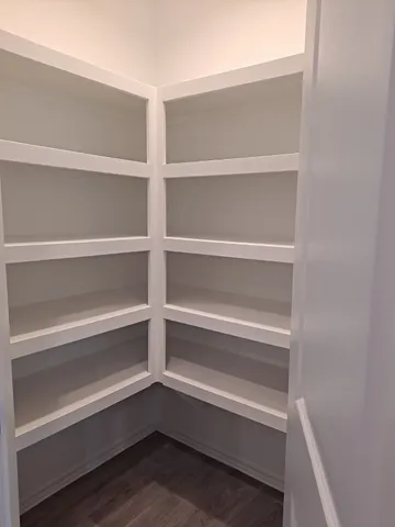 a view of walk in closet with empty racks