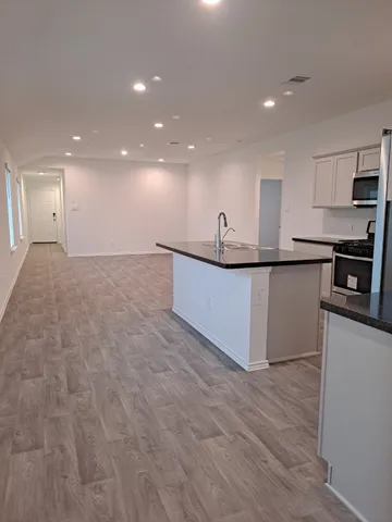 a kitchen with stainless steel appliances granite countertop a sink and cabinets