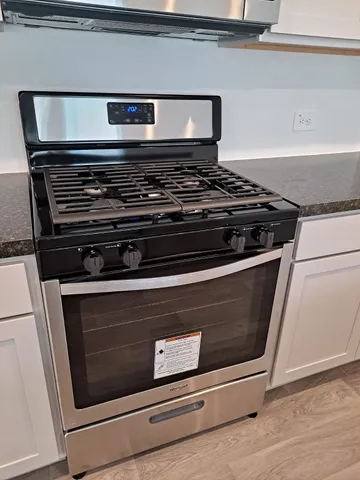 a stove top oven sitting inside of a kitchen