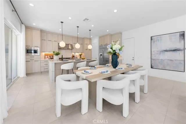 a large kitchen with a table and chairs