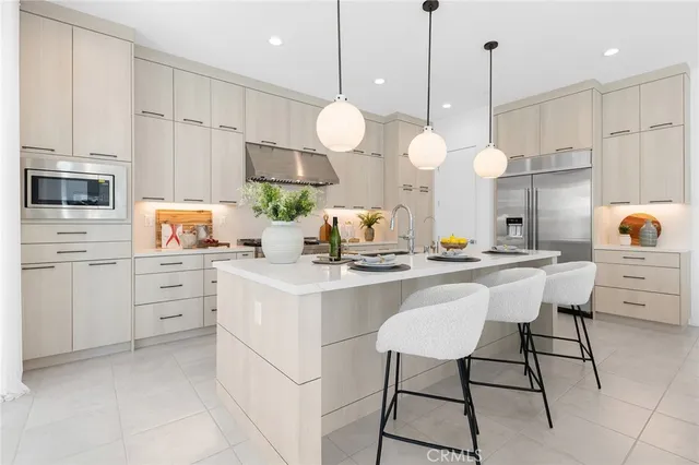 a kitchen with a sink appliances and cabinets