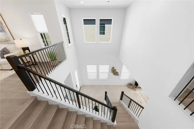 a view of staircase with railing and white walls