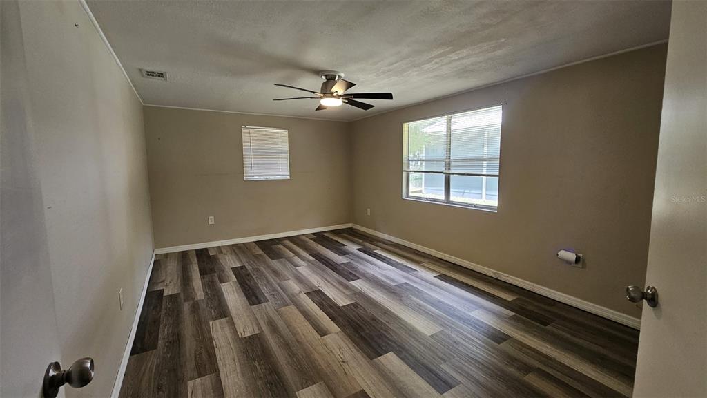 36850 Haynes Road Fruitland Park, FL 34731 - Photo 11 of 28 wooden floor and window in an empty room