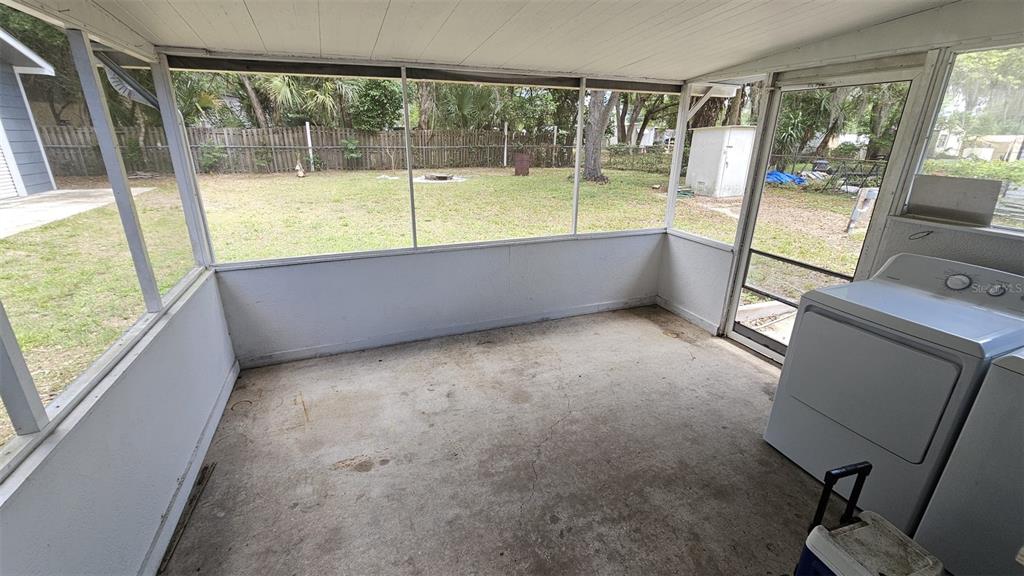 36850 Haynes Road Fruitland Park, FL 34731 - Photo 16 of 28 a view of an empty room with a floor to ceiling window and a flat screen tv