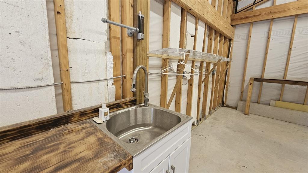 36850 Haynes Road Fruitland Park, FL 34731 - Photo 26 of 28 a bathroom with a sink and a washing machine