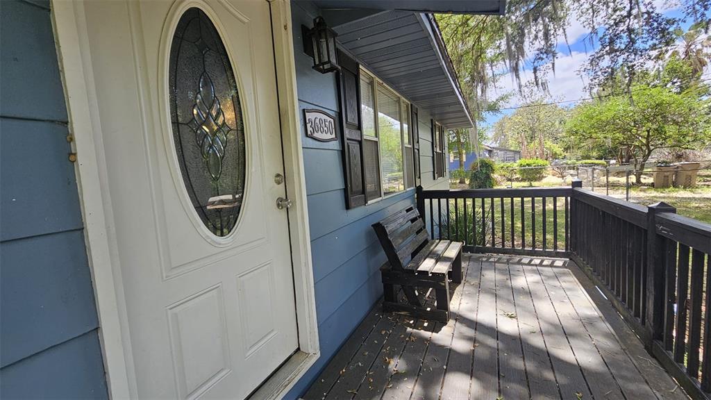 36850 Haynes Road Fruitland Park, FL 34731 - Photo 4 of 28 a view of a porch with wooden floor