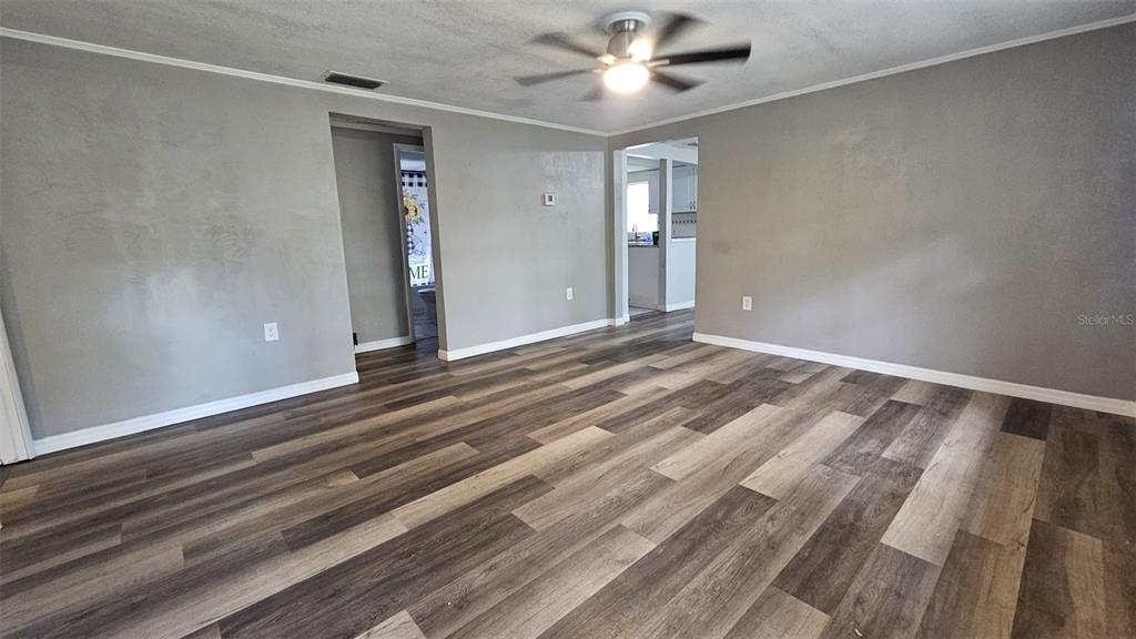 36850 Haynes Road Fruitland Park, FL 34731 - Photo 5 of 28 a view of room with window and ceiling fan