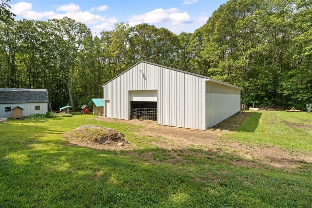 19 Hudson Road Oxford, MA 01540 - Photo 28 of 40 a view of a backyard with a garden and trees