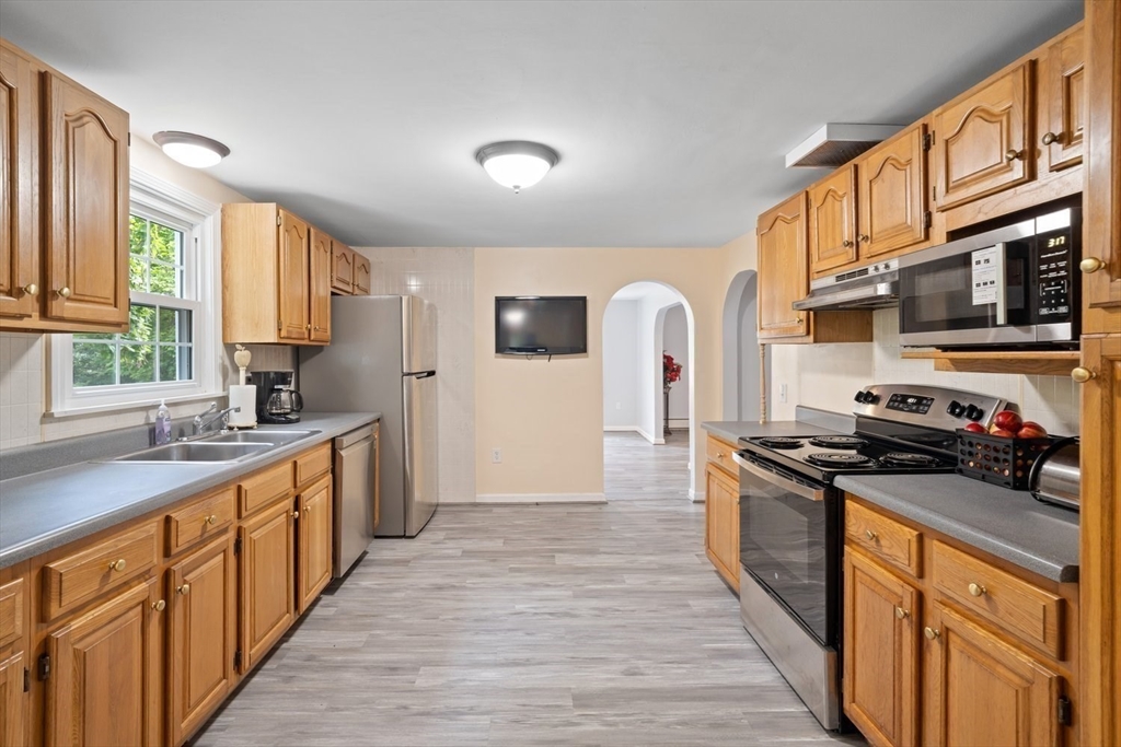 19 Hudson Road Oxford, MA 01540 - Photo 9 of 40 a kitchen with stainless steel appliances granite countertop a stove top oven a sink dishwasher a refrigerator and a cabinets with wooden floor