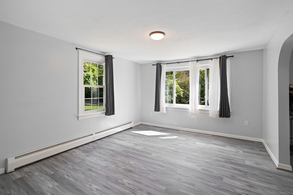 19 Hudson Road Oxford, MA 01540 - Photo 10 of 40 a view of an empty room with wooden floor and a window