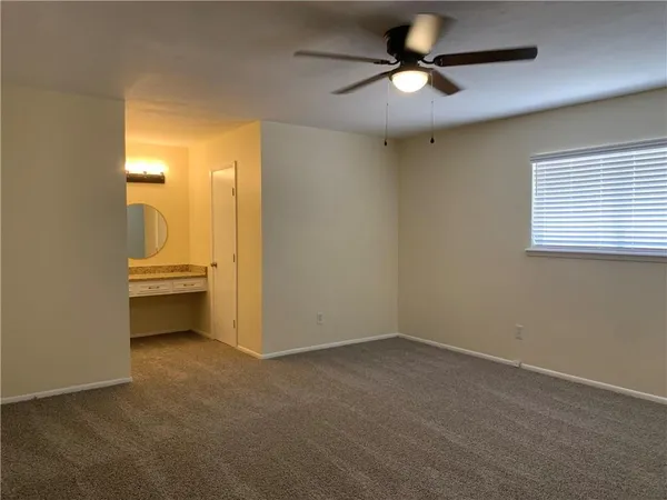 a view of workspace and chandelier fan