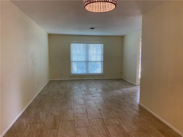 an empty room with wooden floor and a window