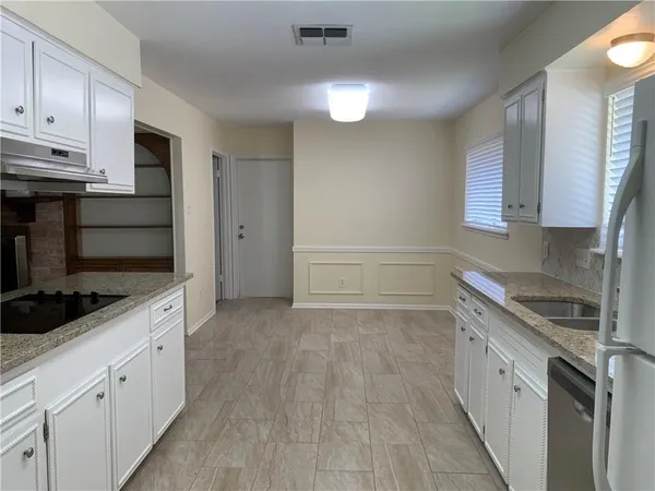 a kitchen with a sink stove and cabinets