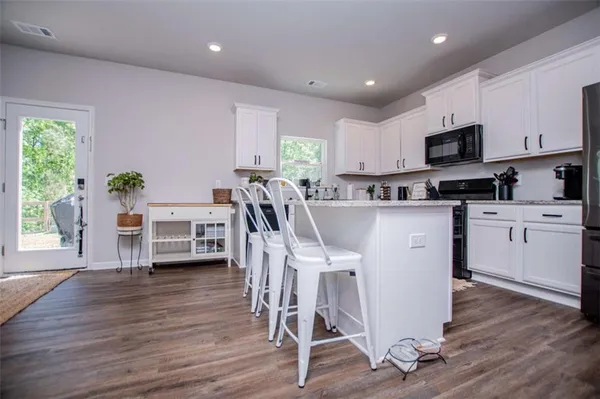 a view of kitchen with cabinets table and chairs